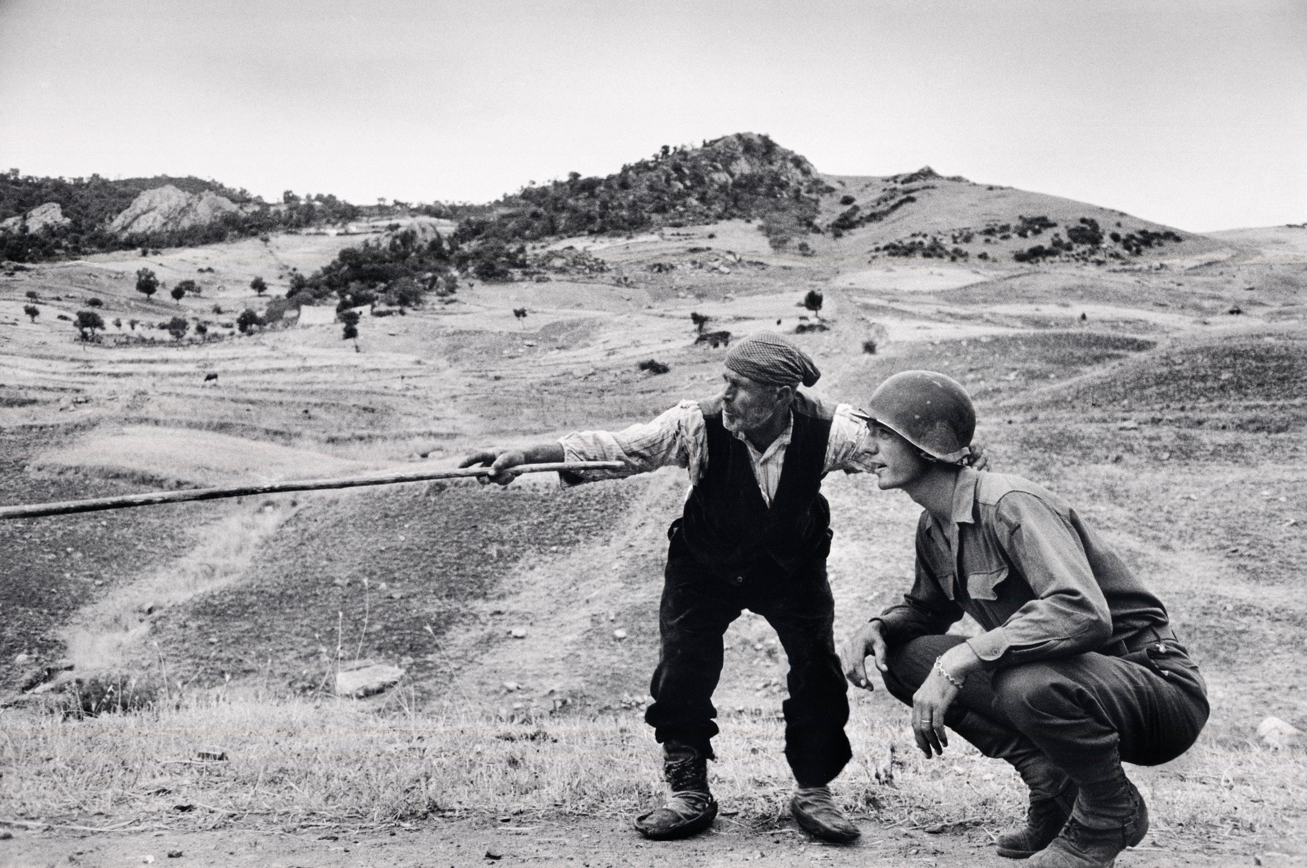 Fine Print: Sicilian peasant telling an American officer which way the Germans had gone. Near Troina, Italy, August, 1943