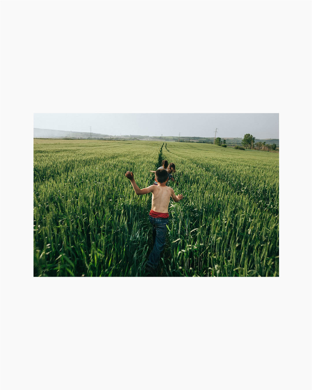 Fine Print: Children run in the wheat field and enjoy nice weather during the local traditional spring festival. Kirklari, Turkey, 2017