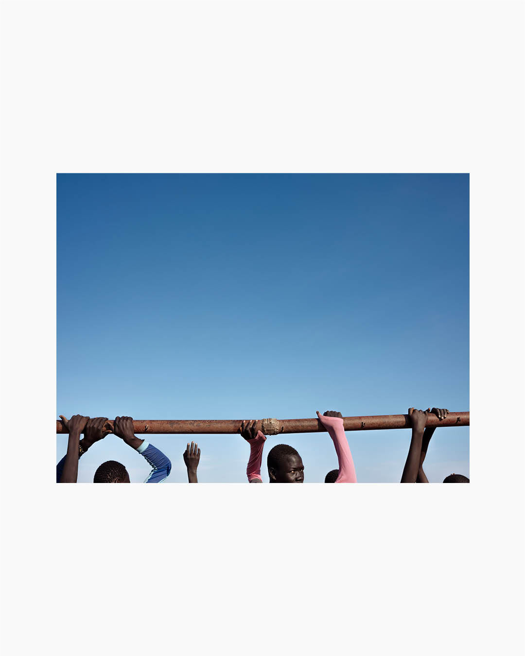 Fine Print: People stand near a playground in POC (Protection of Civilians) site in Bentiu. South Soudan, 2018