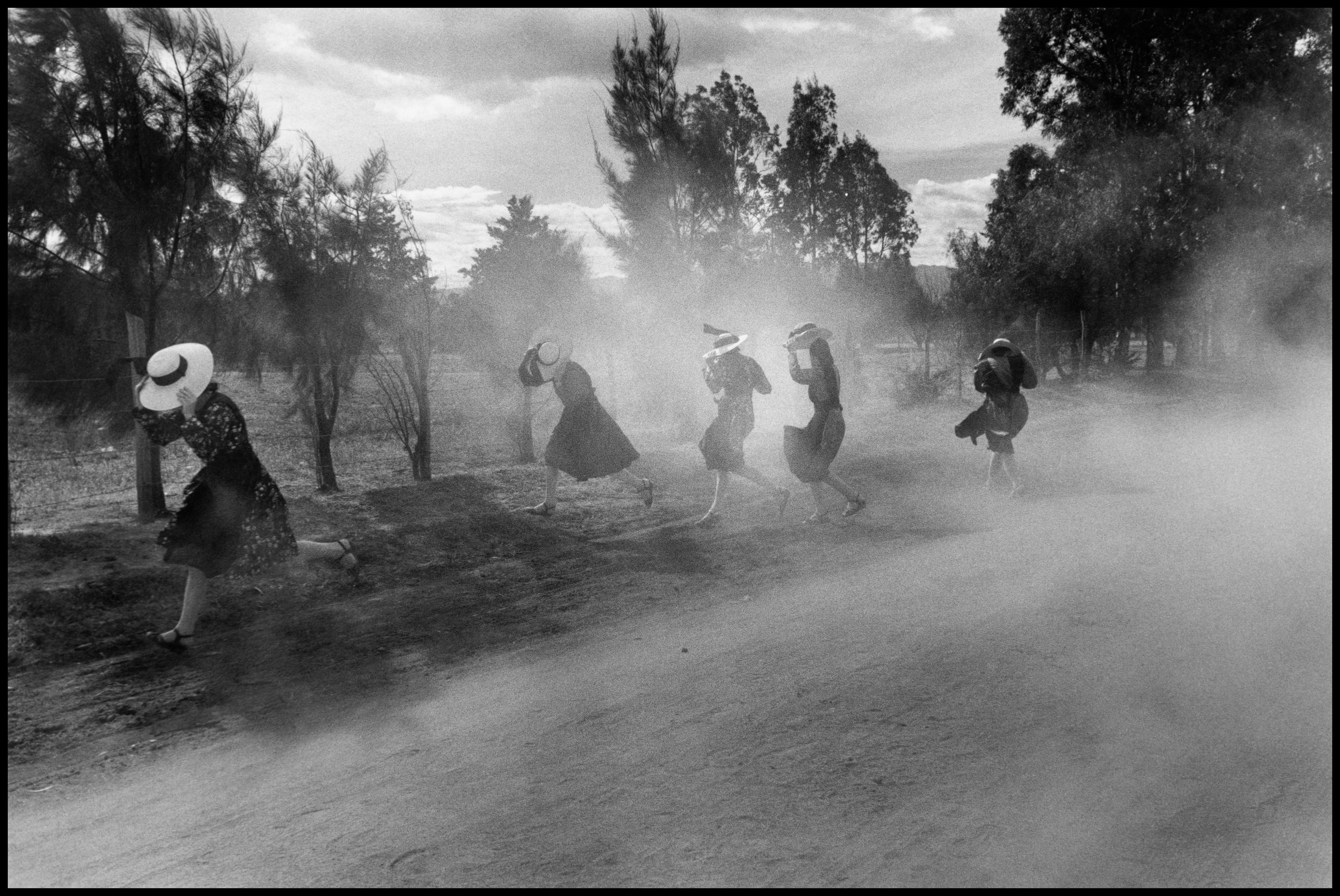 Fine Print: Young Mennonite women fleeing a cloud of dust. Durango, Mexico, 1994