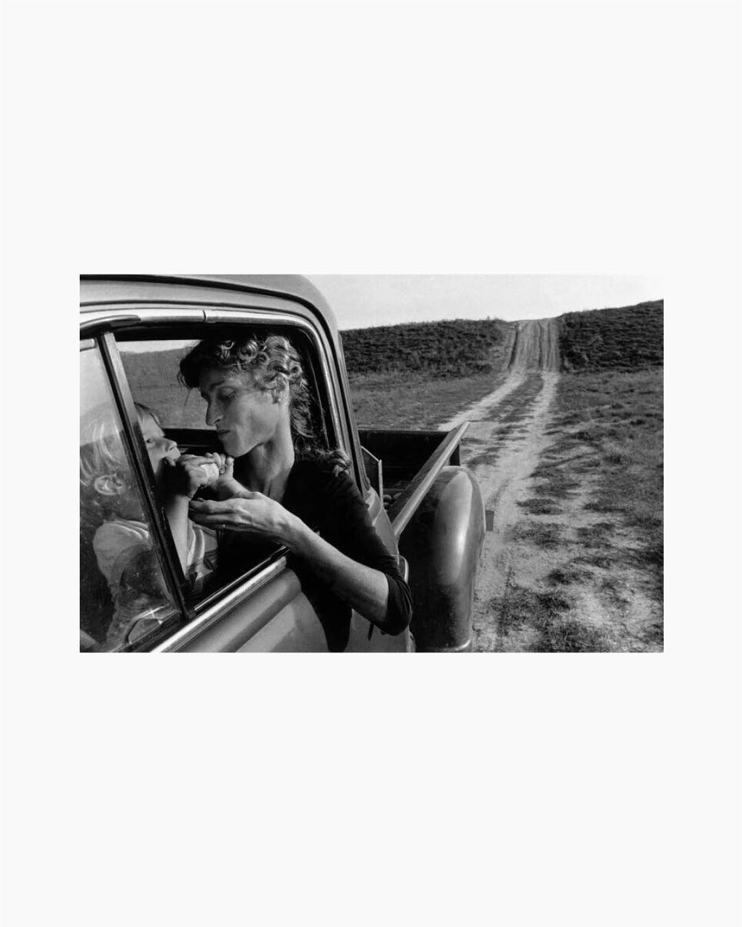 Fine Print: My oldest son Moses Towell eats a wild pear while Ann sits behind the wheel of a 1951 pickup truck. Lambton County, Ontario, Canada, 1983